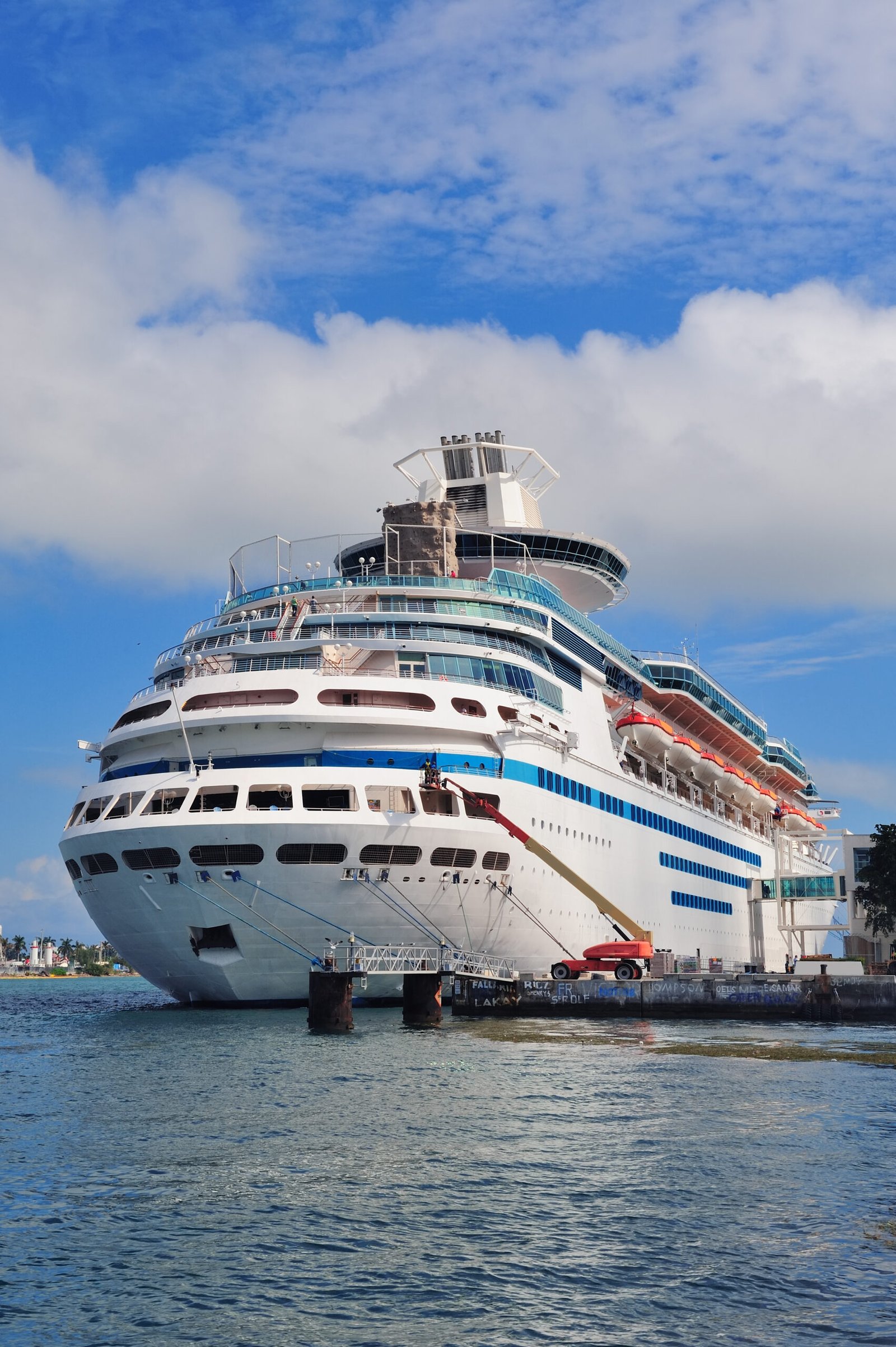 Cruise ship park at Miami dock with cloud and blue sky.