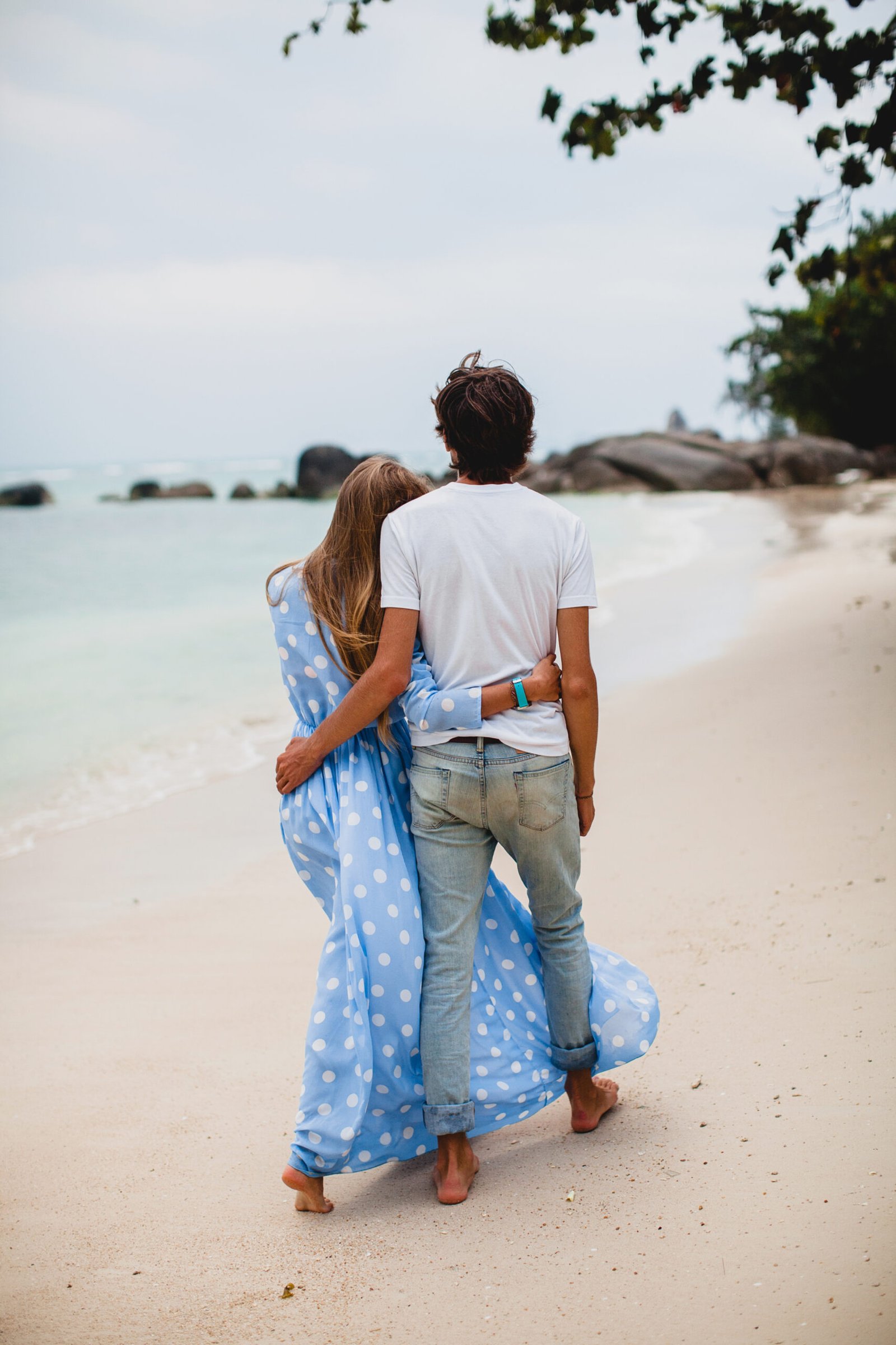 young stylish hipster couple in love on tropical beach during vacation honey moon, embrace, lovely, romance, tenderness, blue dress